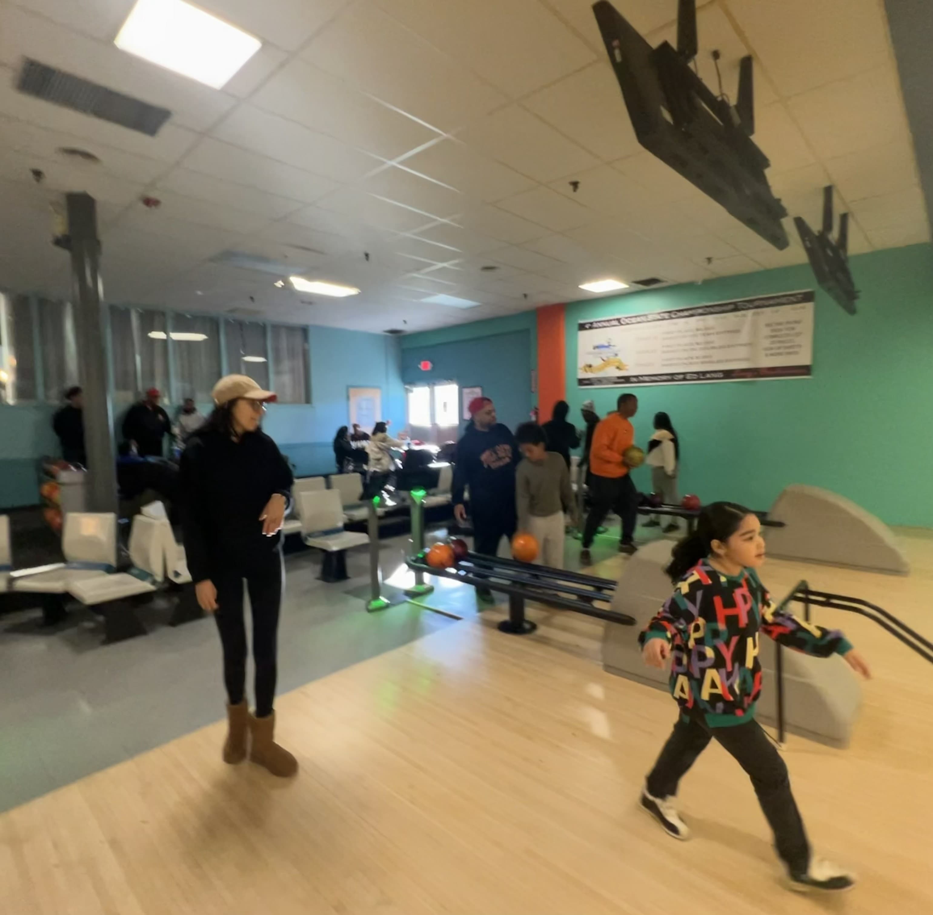 Lead By Example youth and mentors bowling together at a community event