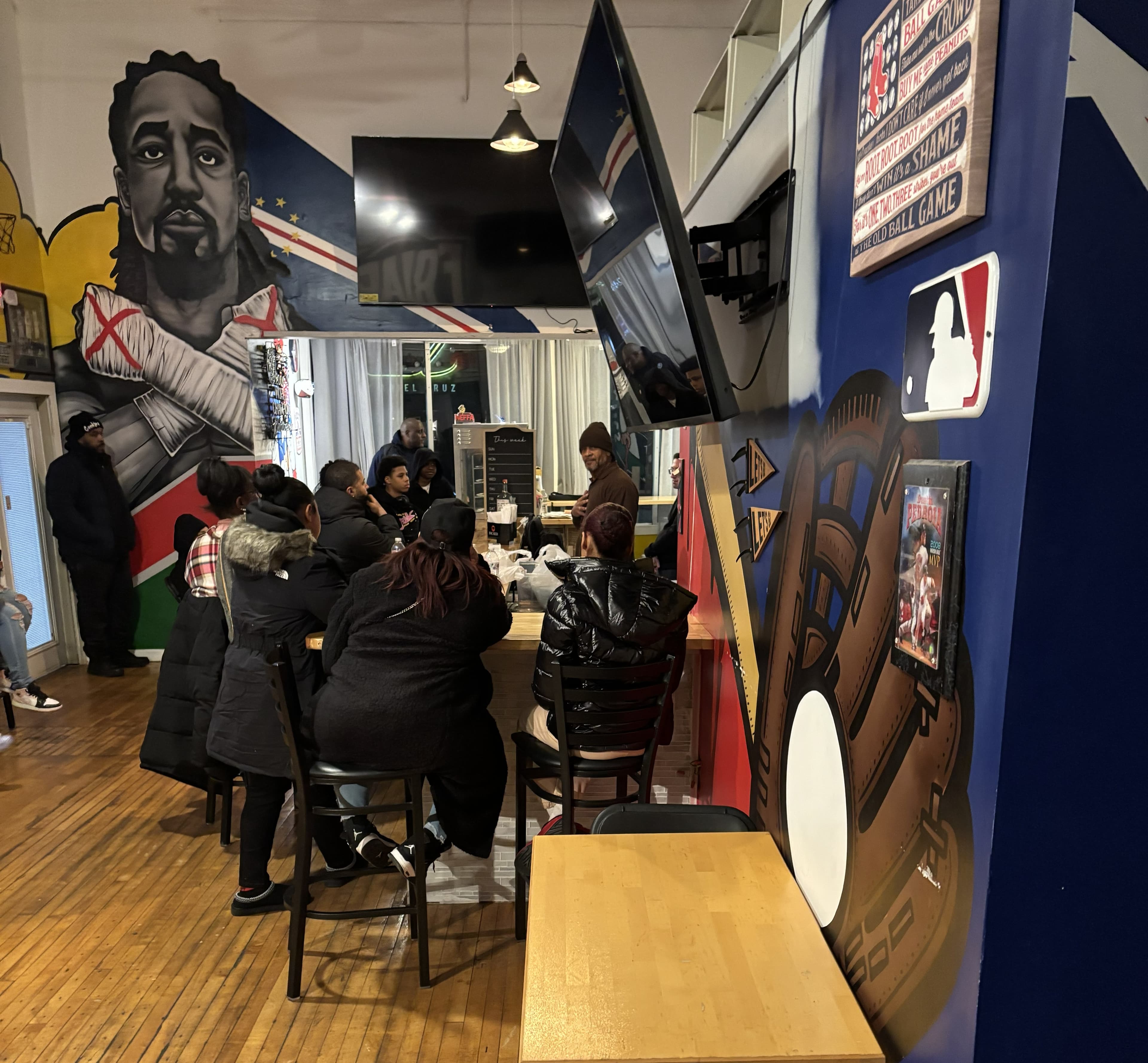 Lead By Example youth and mentors at a community cafe visit