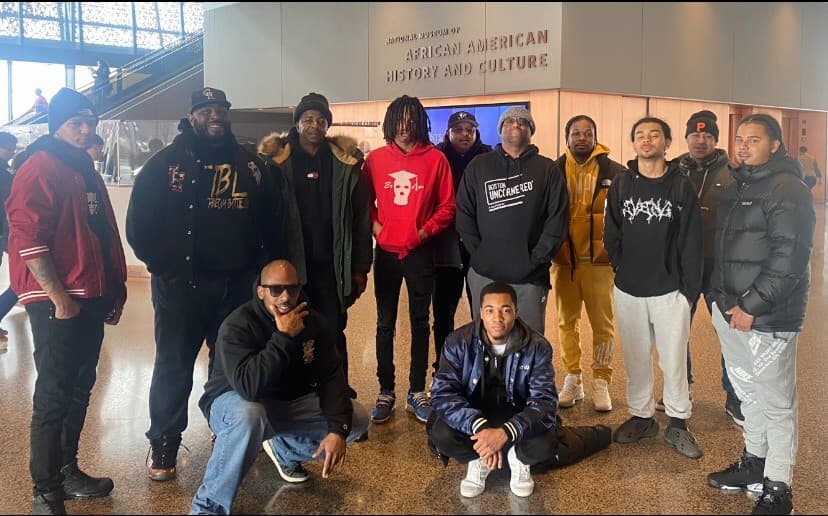 Lead By Example mentors and youth posing at the National Museum of African American History and Culture in Washington D.C.